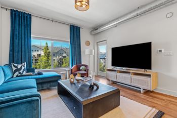 Living room with a blue couch and tv